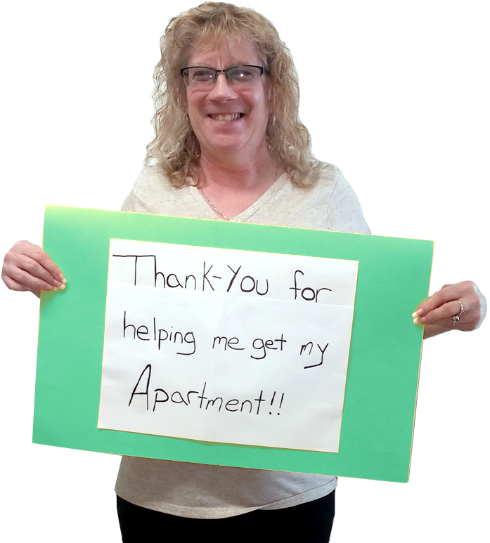 A person with long blonde hair and glasses holding up a sign that says thank you for helping me get my apartment